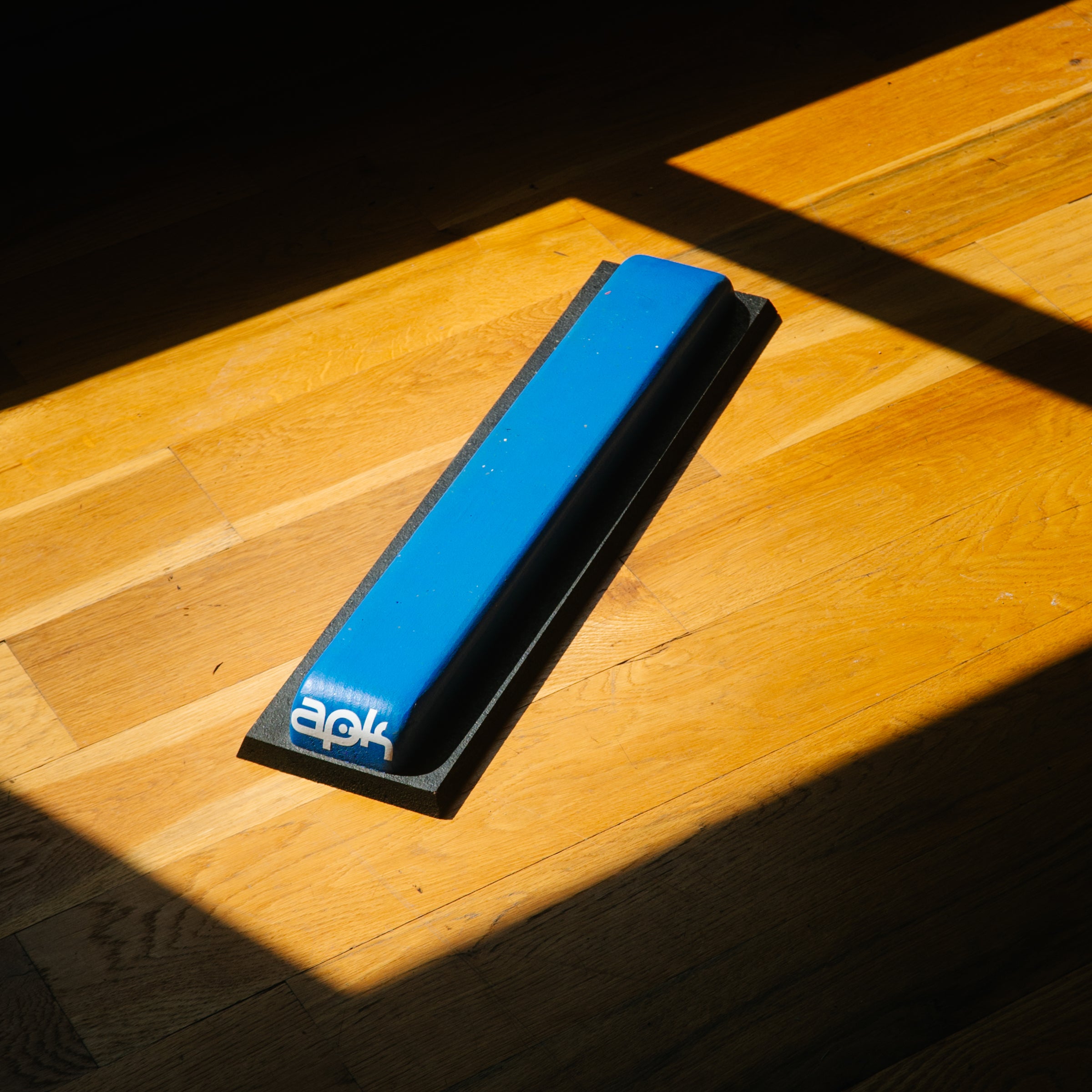 Blue parkour precision jump training on wooden floor